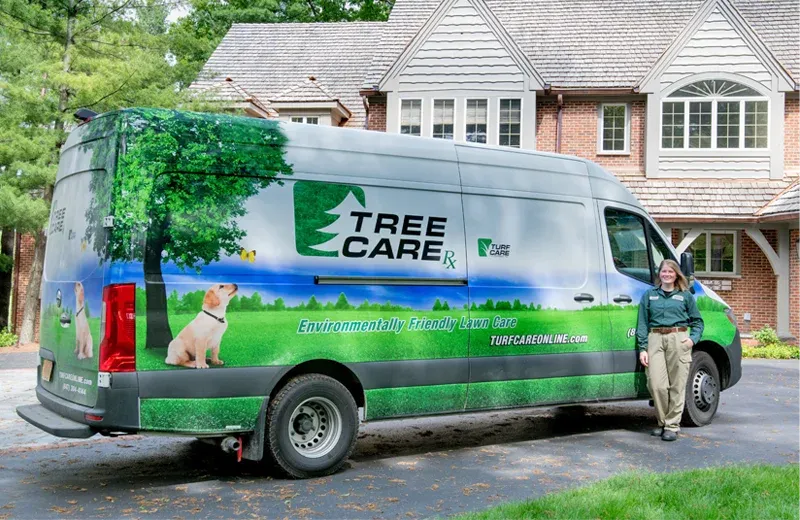 tree care van in front of brick home